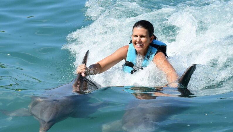 lady swimming with dolphins in montego bay one of the things to do in montego bay